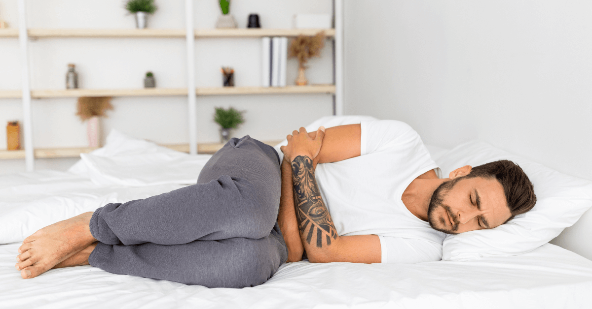 A man laying on his stomach in bed